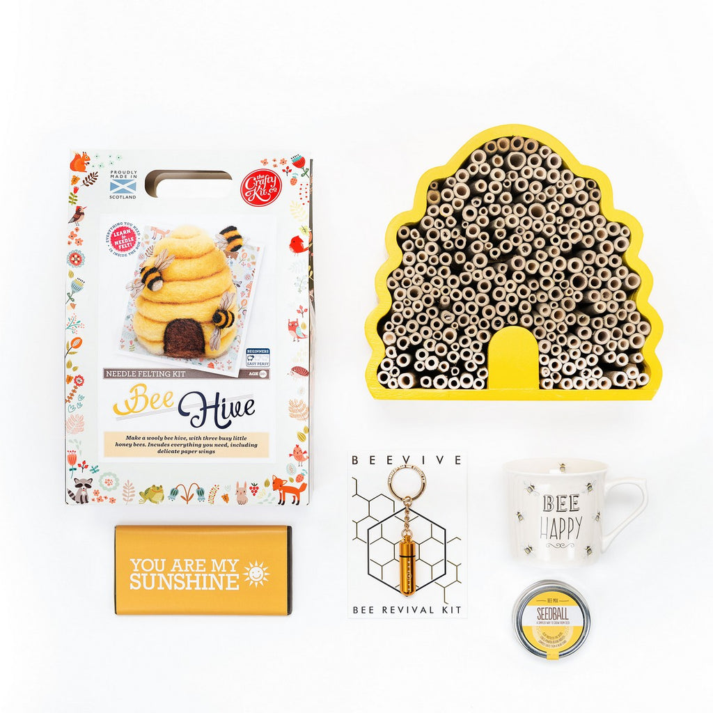 A lovely gardeners gift box with everything bee themed.  A bee hotel to hang outdoors, bee reviver, bee happy mug and a tin of ready to sow seeds to attract our most important garden visitors.