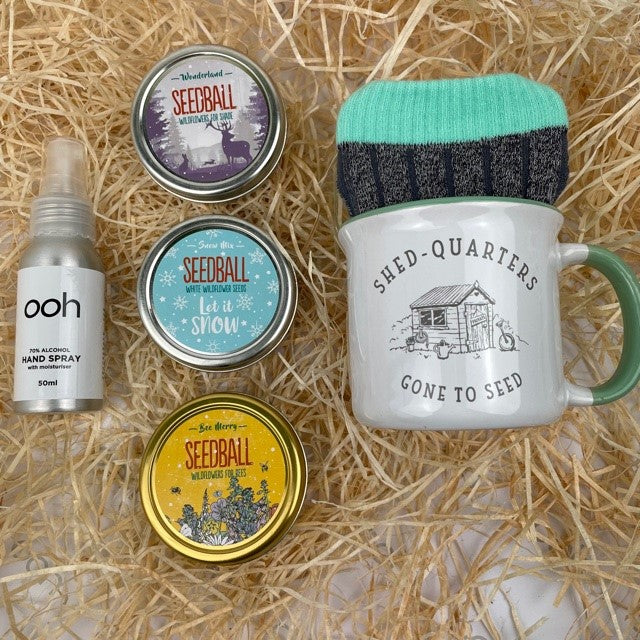 A winter themed gardeners gift with 3 tins of ready to sow seeds, a mug and socks gift and our branded hand sanitiser.